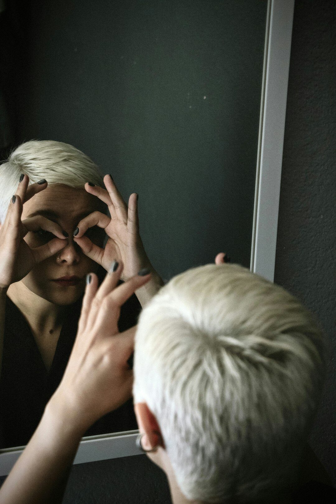 person practicing spanish pronunciation in mirror